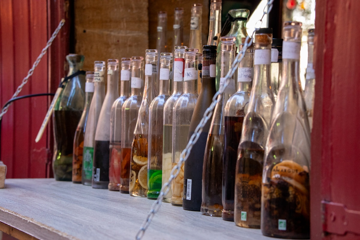 Bottles of various liquids and infusions displayed in a row.